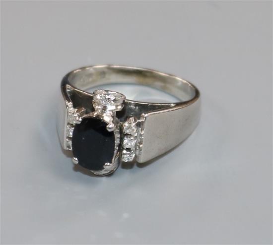 A modern white metal, sapphire and diamond set dress ring, size L.